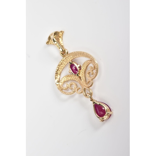 50 - A 9CT GOLD RUBY PENDANT, of open work scrolling design set with a central oval cut ruby suspending a... 