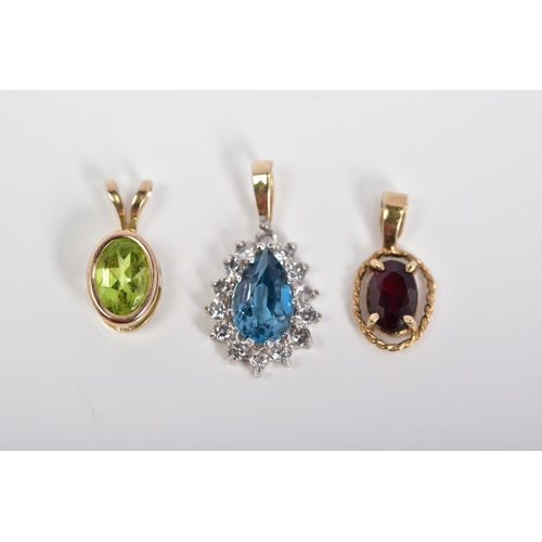 51 - THREE PENDANTS, the first of 9ct gold set with an oval cut garnet within a rope twist surround, with... 