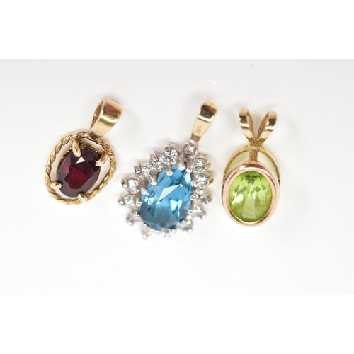 51 - THREE PENDANTS, the first of 9ct gold set with an oval cut garnet within a rope twist surround, with... 