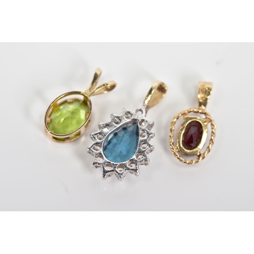 51 - THREE PENDANTS, the first of 9ct gold set with an oval cut garnet within a rope twist surround, with... 