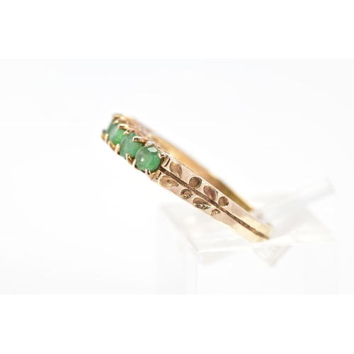 52 - A 9CT GOLD EMERALD RING, set with a row of five circular cut emeralds to the engraved shoulders, wit... 