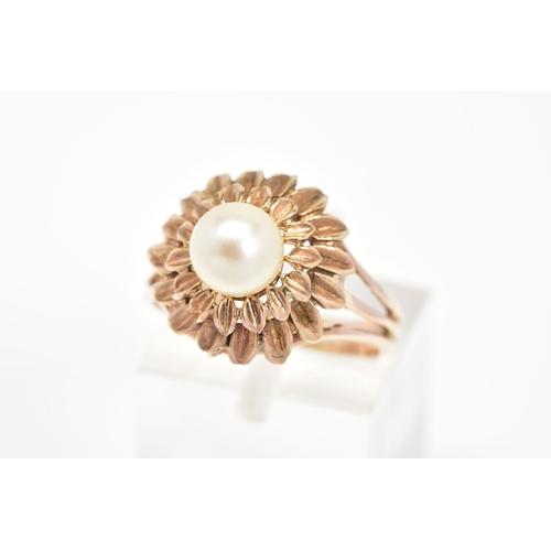 57 - A CULTURED PEARL RING, of a tiered floral design set with a single central cultured pearl, ring size... 