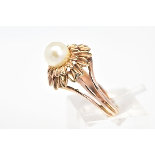 57 - A CULTURED PEARL RING, of a tiered floral design set with a single central cultured pearl, ring size... 