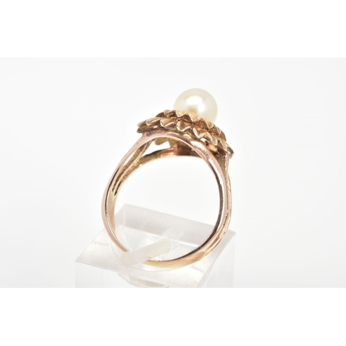 57 - A CULTURED PEARL RING, of a tiered floral design set with a single central cultured pearl, ring size... 