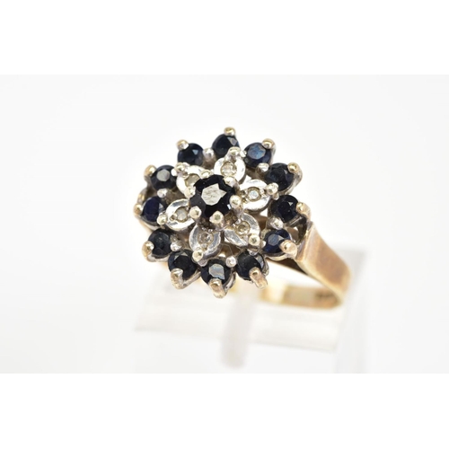 58 - A 9CT GOLD SAPPHIRE AND DIAMOND RING, of cluster design set with thirteen circular cut sapphires and... 