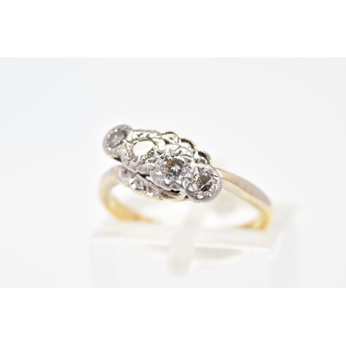 59 - A FOUR STONE DIAMOND RING, of cross over design featuring a row of four diamonds, two brilliant cut,... 