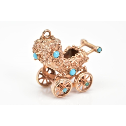 62 - A 9CT GOLD CHARM, designed as a vintage pram set with turquoise stones, with rotating wheels, with 9... 