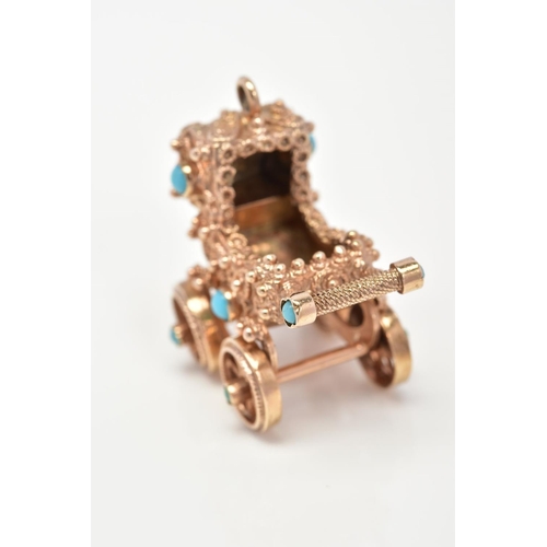 62 - A 9CT GOLD CHARM, designed as a vintage pram set with turquoise stones, with rotating wheels, with 9... 