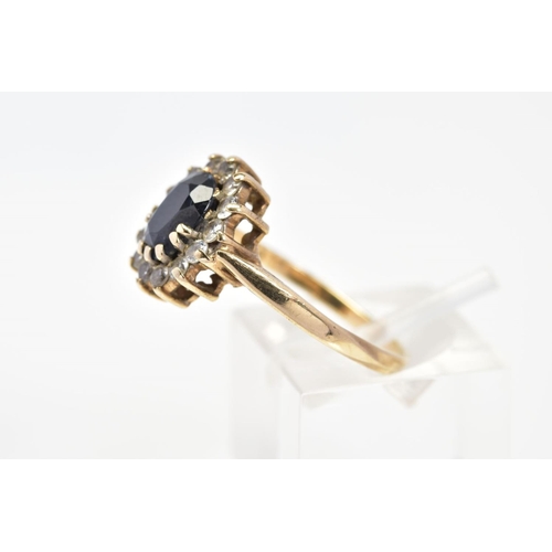 68 - A 9CT GOLD SAPPHIRE AND CUBIC ZIRCONIA CLUSTER RING, set with a central oval cut sapphire and colour... 