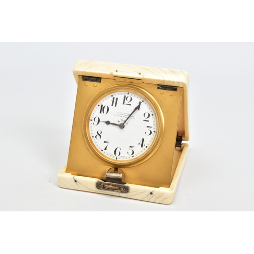 75 - AN EARLY 20TH CENTURY IVORY CASED TRAVEL CLOCK, of square design with applied silver monogram to lid... 