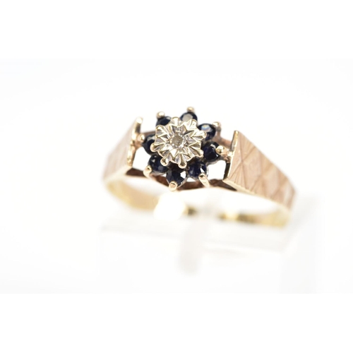 84 - A 9CT GOLD SAPPHIRE AND DIAMOND CLUSTER RING, the central single cut diamond in a star illusion sett... 