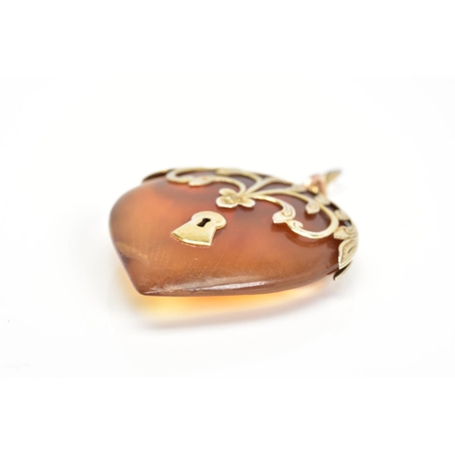 86 - A LATE VICTORIAN BLONDE TORTOISESHELL PENDANT, the pear shape tortoiseshell pendant with applied fol... 