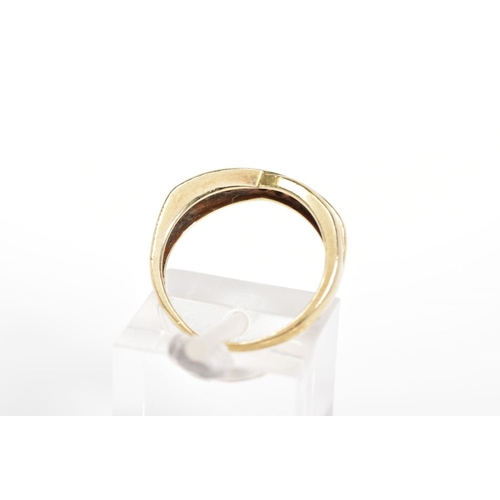 91 - A 9CT GOLD RING, the cross over design set with a diagonal line of channel set circular cubic zircon... 