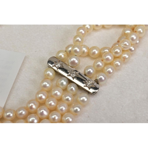 97 - A FOUR ROW CULTURED PEARL CHOKER NECKLACE WITH DIAMONDS, designed as four rows of spherical cultured... 