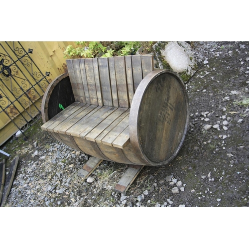 1004 - A BOURBON WHISKEY BARREL GARDEN BENCH with barrel staves as seat, back and feet, length 88cm