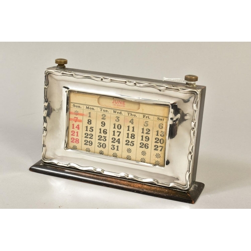 101 - A GEORGE V STYLE MOUNTED PERPETUAL CALENDAR, of rectangular form, wavy edge to the frame, bears regi... 