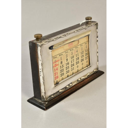 101 - A GEORGE V STYLE MOUNTED PERPETUAL CALENDAR, of rectangular form, wavy edge to the frame, bears regi... 