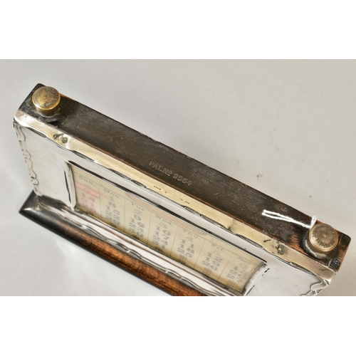 101 - A GEORGE V STYLE MOUNTED PERPETUAL CALENDAR, of rectangular form, wavy edge to the frame, bears regi... 