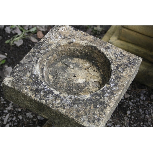 1011 - A COMPOSITE TWO PIECE BIRD BATH with a two tier stepped base, a square stem with detailed edges and ... 