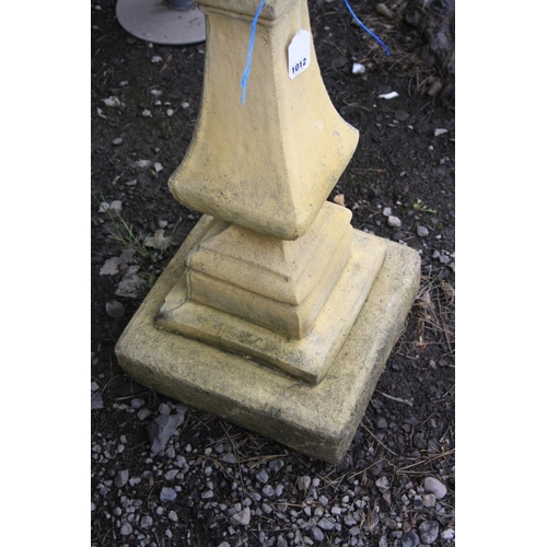 1012 - A COMPOSITE TWO PIECE BIRD BATH with a stepped and detailed base, square baluster tapering stem and ... 