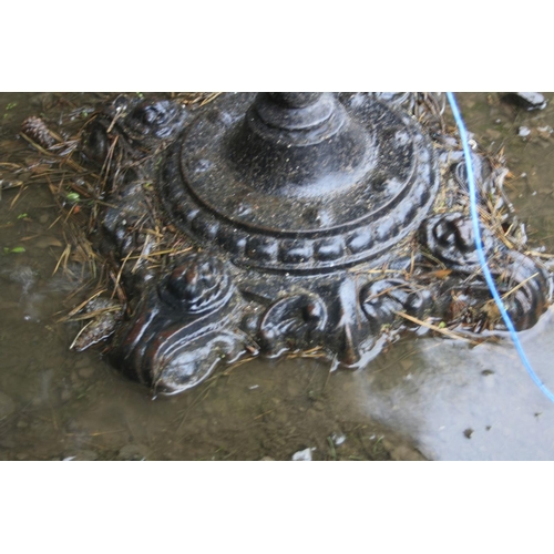 1017 - A VICTORIAN CAST IRON PUB TABLE with a footed circular base with foliate detail and a single cylindr... 