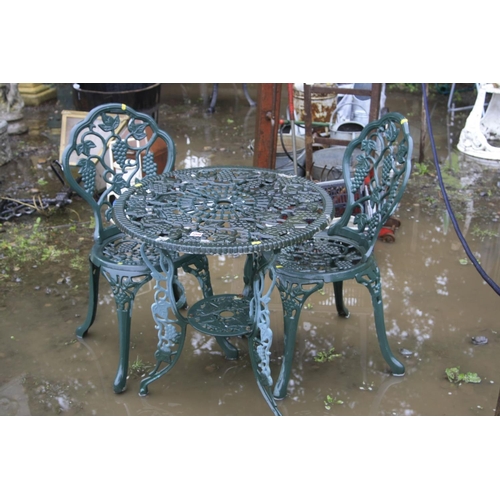 1027 - A GREEN CAST ALUMINIUM CIRCULAR GARDEN TABLE, diameter 65cm a pair of matching chairs (sd) and a set... 