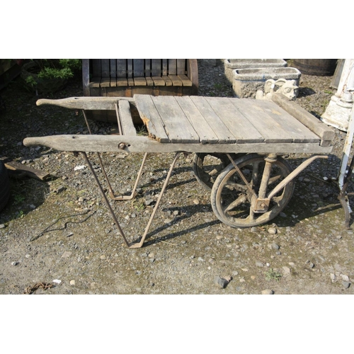 1031 - A VINTAGE BRICKMAKERS TROLLEY with an oak frame, cast iron axle frame and wheels and an iron stand, ... 