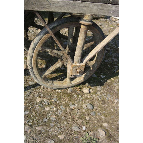 1031 - A VINTAGE BRICKMAKERS TROLLEY with an oak frame, cast iron axle frame and wheels and an iron stand, ... 