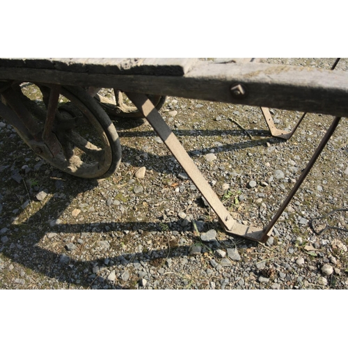 1031 - A VINTAGE BRICKMAKERS TROLLEY with an oak frame, cast iron axle frame and wheels and an iron stand, ... 