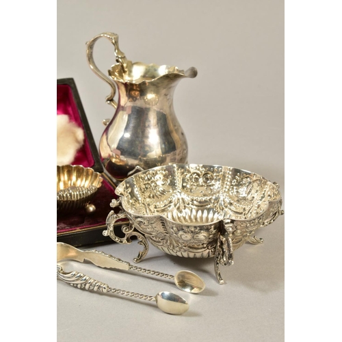 104 - A GROUP OF SILVER, comprising a late Victorian bon bon dish, repousse decorated on four cast scroll ... 