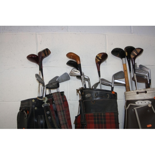 1107 - SIX GOLF BAGS including clubs of various makers and a vintage tennis racket