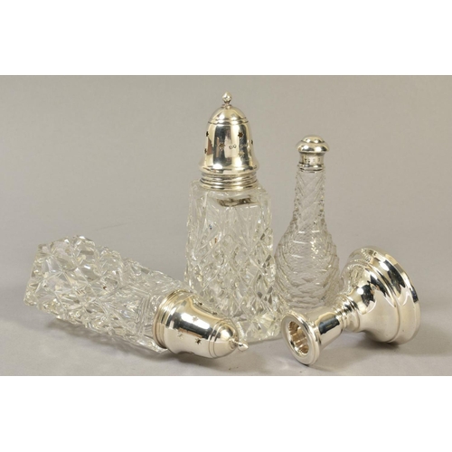 112 - A NEAR PAIR OF ELIZABETH II SILVER TOPPED GLASS SUGAR CASTERS, London 1969 and 1972, together with a... 