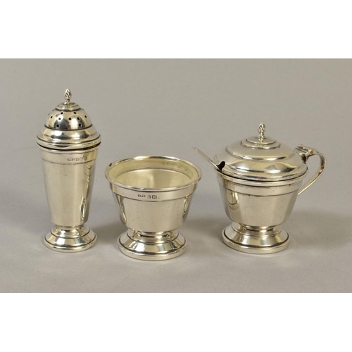 120 - A GEORGE VI SILVER THREE PIECE CRUET SET, of conical form, comprising pepperette, open salt with gla... 