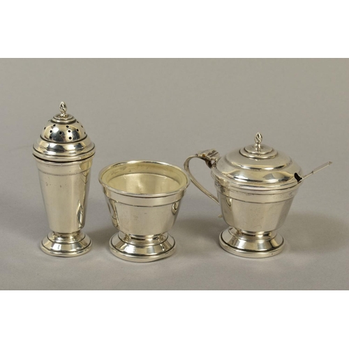 120 - A GEORGE VI SILVER THREE PIECE CRUET SET, of conical form, comprising pepperette, open salt with gla... 