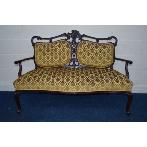 1202 - A VICTORIAN MAHOGANY FOLIATE UPHOLSTERED TWO SEATER SERPENTINE FRONTED SETTEE, flanked with two back... 