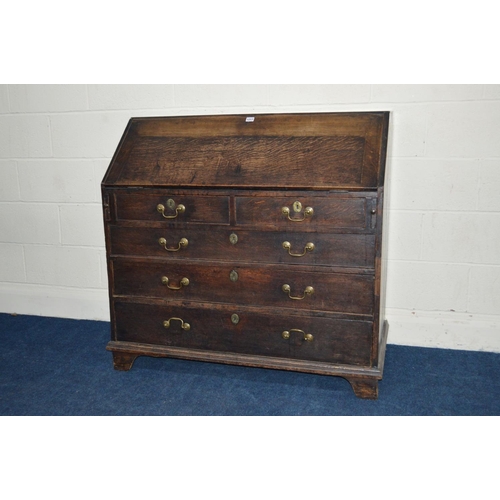 1217 - A GEORGIAN OAK BUREAU, fitted interior, above two short and three long drawers, with swan neck handl... 