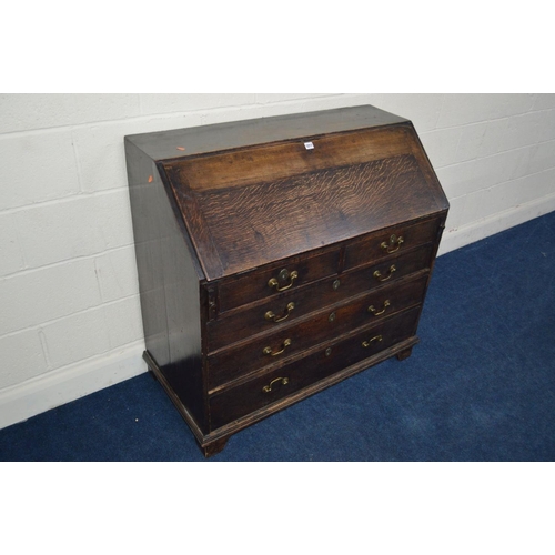 1217 - A GEORGIAN OAK BUREAU, fitted interior, above two short and three long drawers, with swan neck handl... 