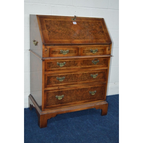 1219 - A REPRODUCTION LADIES BURR WALNUT BUREAU with two short and three long graduating drawers, inside a ... 