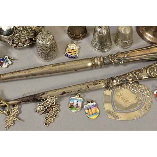 122 - A QUANTITY OF SILVER ITEMS, including two napkin rings, silver handled button hooks, two silver thim... 