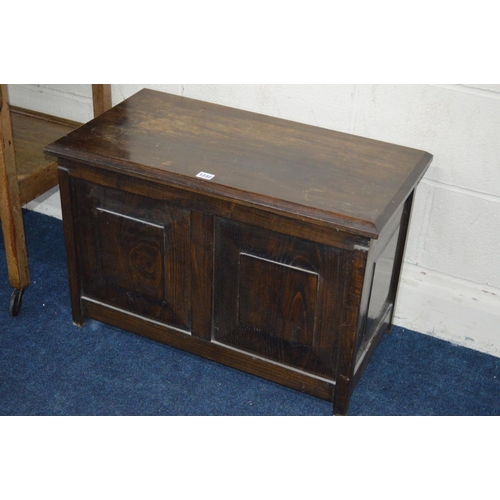 1232 - AN OAK PANELLED BLANKET CHEST together with an oak drop leaf tea trolley (2)