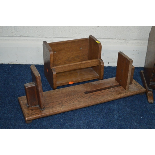 1233 - A REPRODUCTION OAK MAGAZINE RACK together with an oak bookstand with a lamp attachment and two other... 