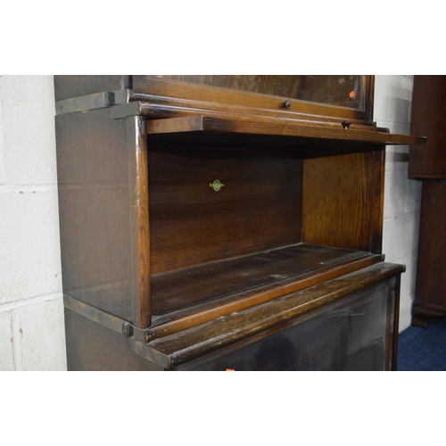 1243 - AN OAK FOUR SECTIONAL BOOKCASE, the Globe-Wernicke Co Limited, London, with glazed flap front sectio... 