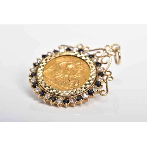 13 - A HALF SOVEREIGN PENDANT, the Victoria 1898 half sovereign within a sapphire and colourless paste su... 