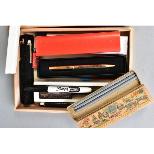 134 - TWO SLIM WOODEN TRAYS CONTAINING MOSTLY VINTAGE PENS AND PENCILS, including a boxed John Bull founta... 