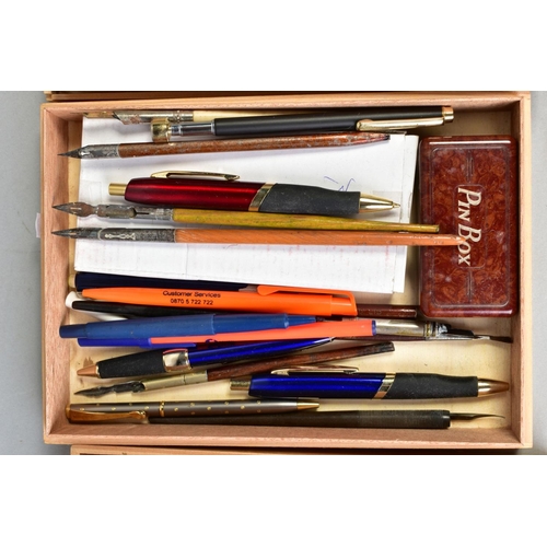 134 - TWO SLIM WOODEN TRAYS CONTAINING MOSTLY VINTAGE PENS AND PENCILS, including a boxed John Bull founta... 