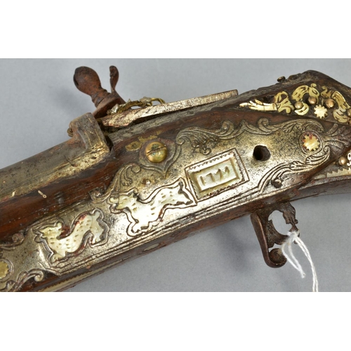 142 - AN ANTIQUE ARAB FLINTLOCK MUZZLE LOADING MUSKET, with decorative bone and mother of pearl inlays to ... 