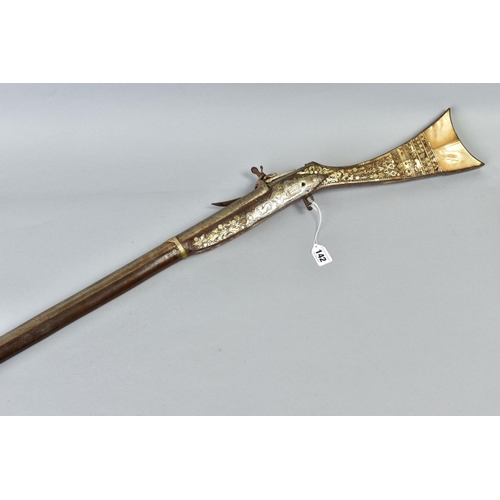 142 - AN ANTIQUE ARAB FLINTLOCK MUZZLE LOADING MUSKET, with decorative bone and mother of pearl inlays to ... 