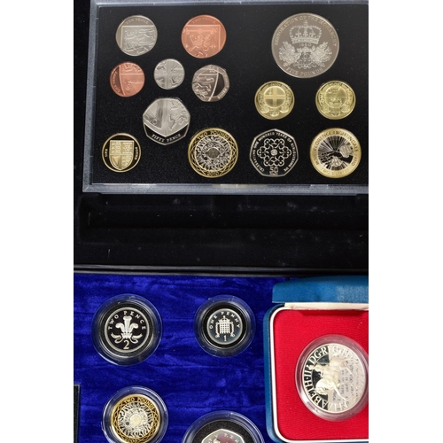 154 - A CARDBOARD BOX CONTAINING UK ROYAL MINT COIN PROOF SETS to include two three cased one pound silver... 