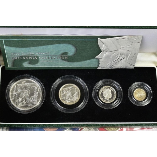 154 - A CARDBOARD BOX CONTAINING UK ROYAL MINT COIN PROOF SETS to include two three cased one pound silver... 