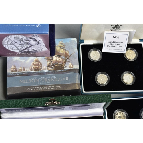 154 - A CARDBOARD BOX CONTAINING UK ROYAL MINT COIN PROOF SETS to include two three cased one pound silver... 